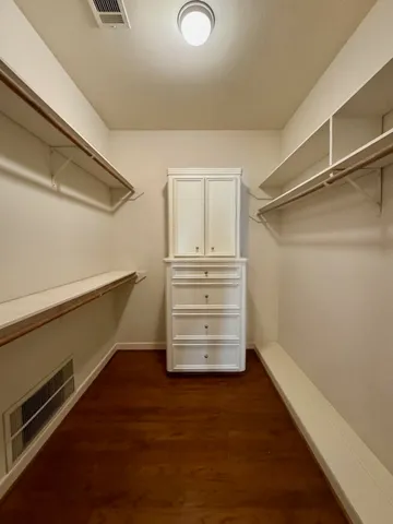 a view of walk in closet with empty racks