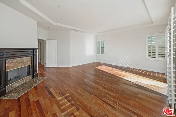 a view of empty room with window and fireplace