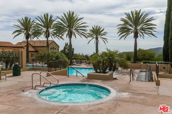 a view of a swimming pool with a table and chairs