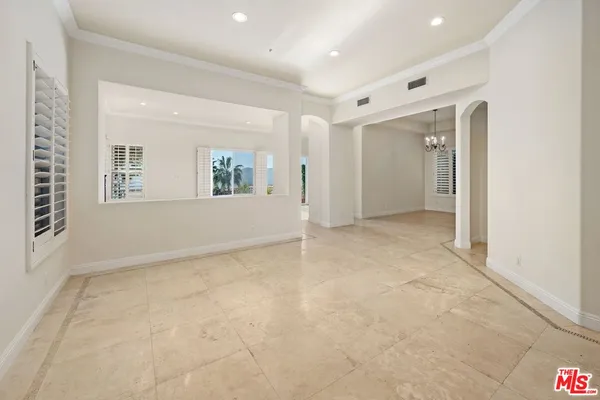 an empty room with windows and entrance