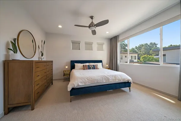 a bedroom with a large bed and a window
