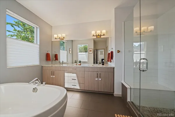 a spacious bathroom with a double vanity sink mirror and double