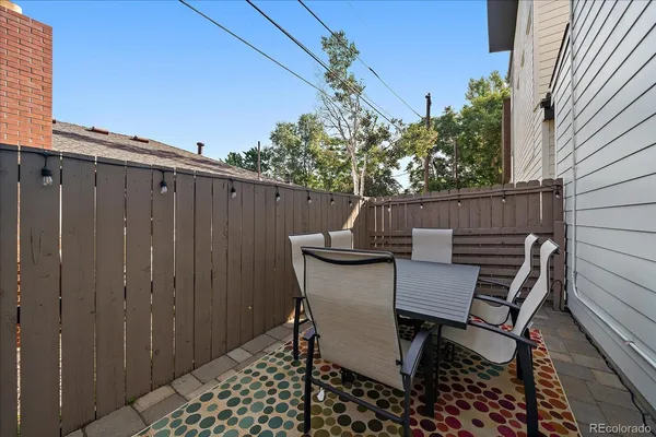 a view of a chairs and table in the balcony