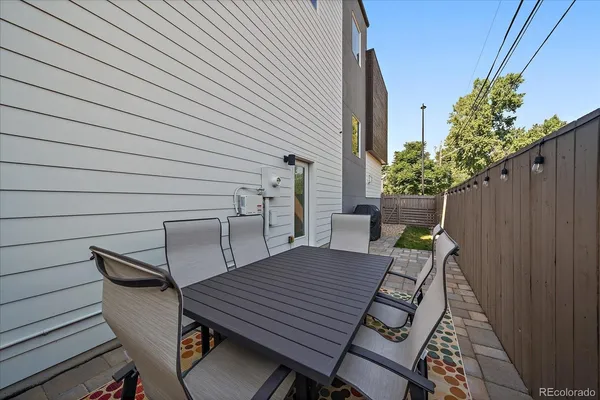 a wooden bench sitting in backside of a house