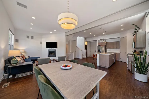 a view of a dining room and furniture kitchen with wooden floor