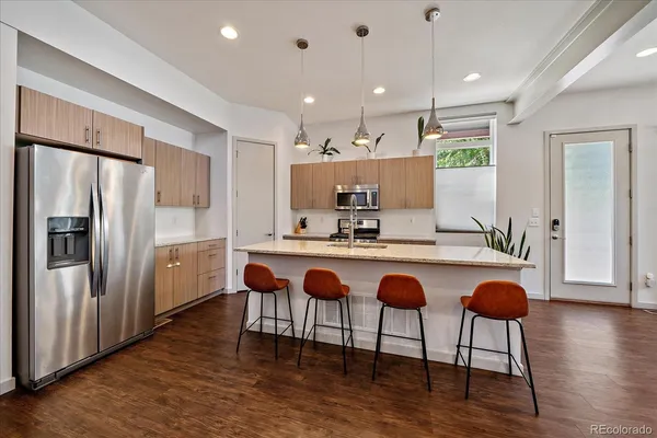 a kitchen with granite countertop a counter space dining table and stainless steel appliances