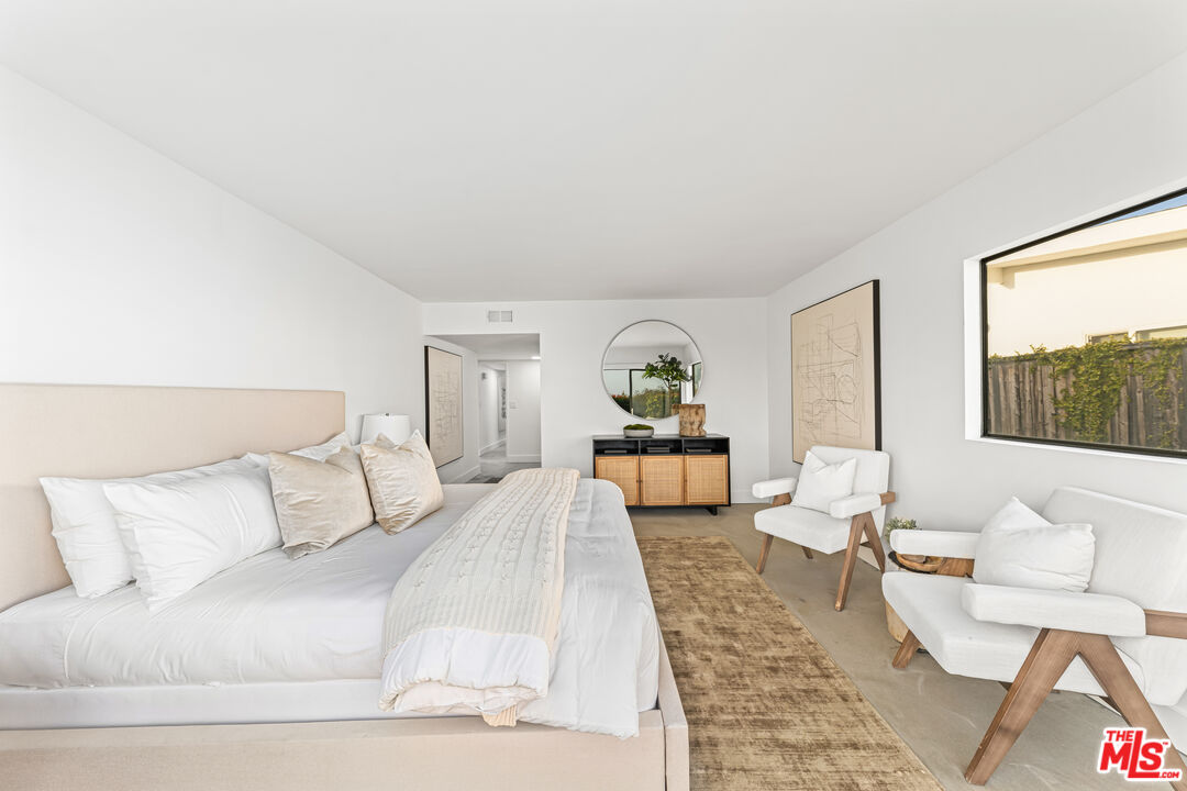 18440 Wakecrest Drive Malibu, CA 90265 - Photo 16 of 29 a bedroom with a large bed and a couch