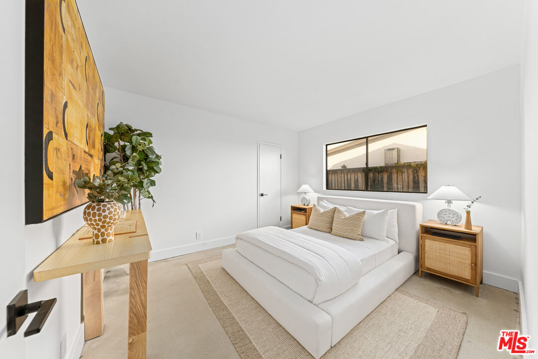 18440 Wakecrest Drive Malibu, CA 90265 - Photo 19 of 29 a bedroom with a bed table flowerpot and window