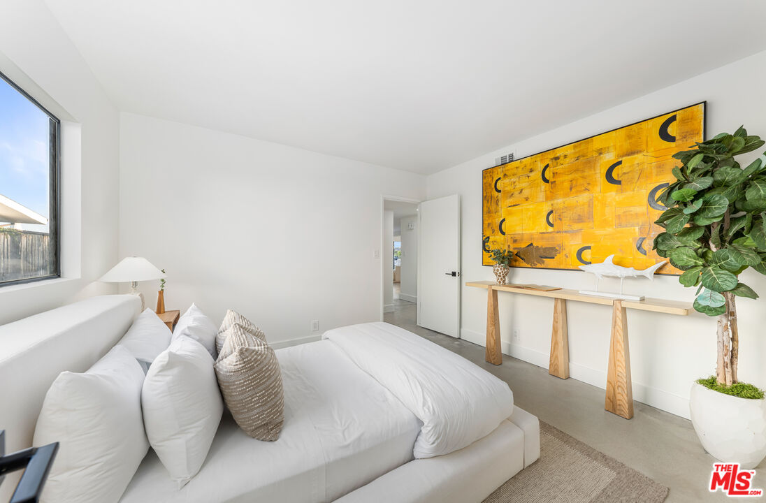 18440 Wakecrest Drive Malibu, CA 90265 - Photo 20 of 29 a bedroom with a bed and a painting on the wall