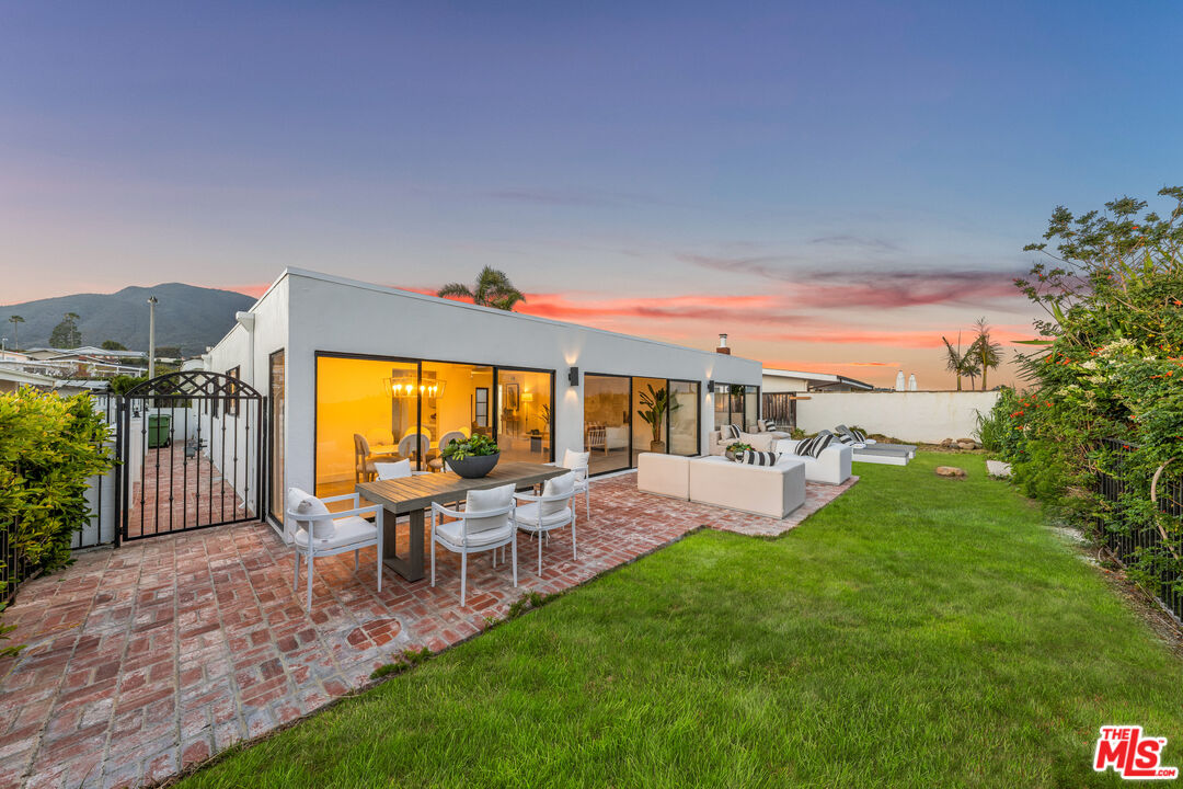 18440 Wakecrest Drive Malibu, CA 90265 - Photo 24 of 29 a view of a patio with couches chairs potted plants and large tree