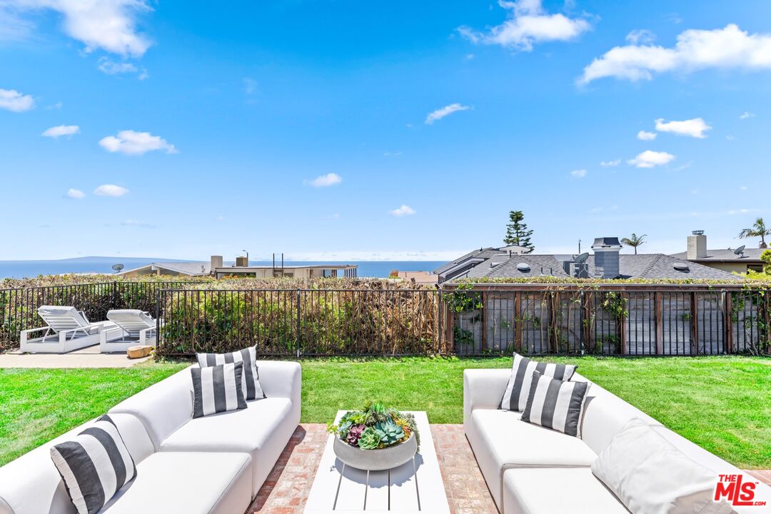 18440 Wakecrest Drive Malibu, CA 90265 - Photo 29 of 29 a view of a patio with couches chairs and a yard