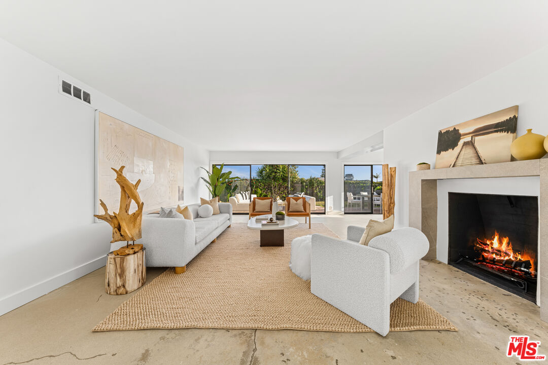 18440 Wakecrest Drive Malibu, CA 90265 - Photo 5 of 29 a living room with furniture and a fireplace