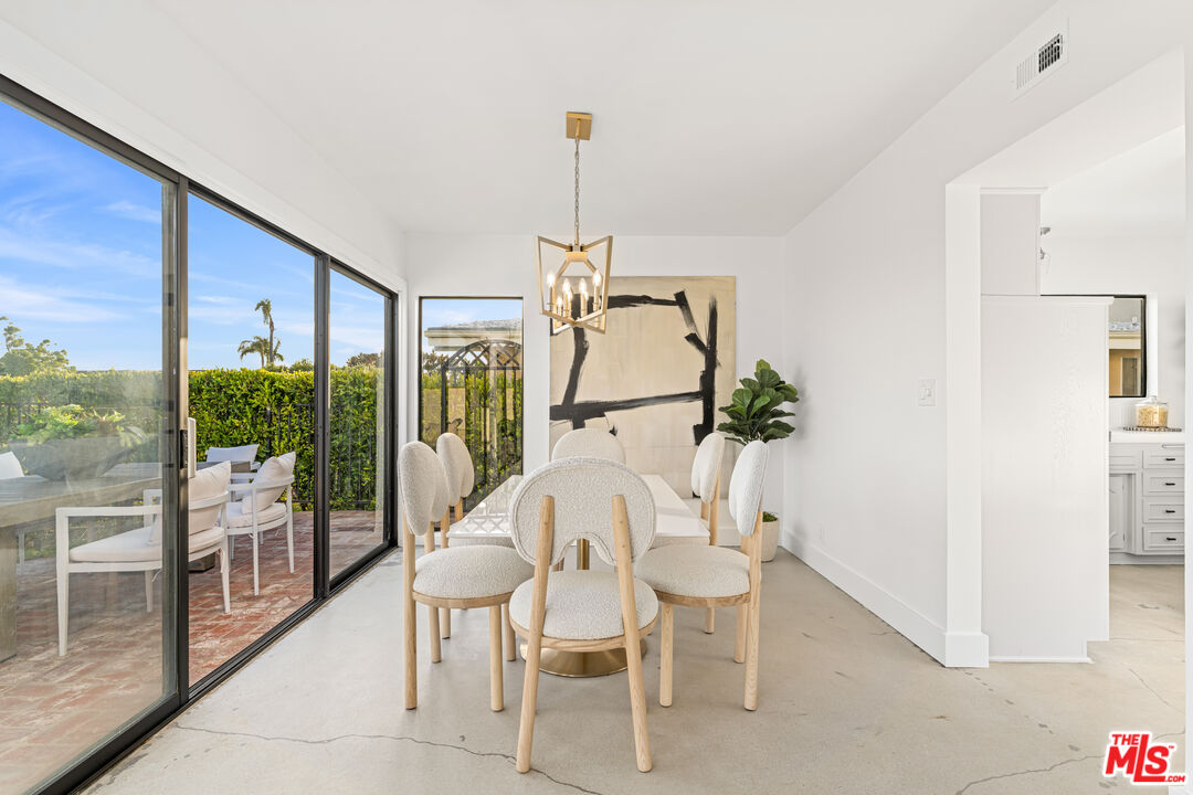 18440 Wakecrest Drive Malibu, CA 90265 - Photo 9 of 29 a dining room with furniture and floor to ceiling window