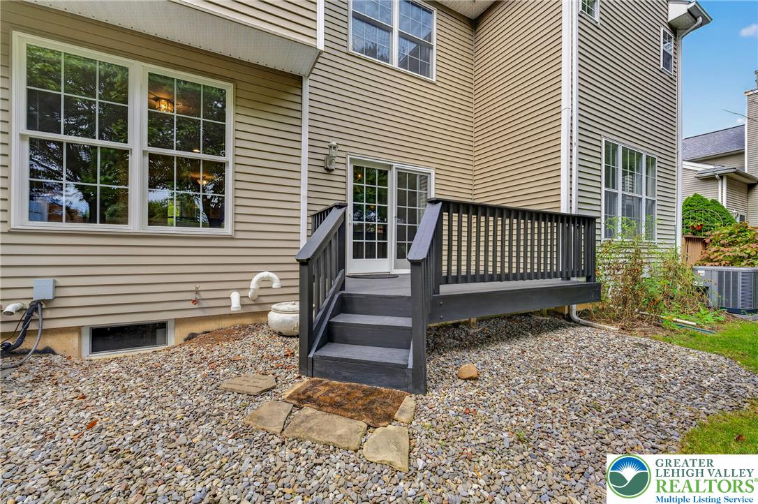 4236 Creek Road Allentown, PA 18104 - Photo 41 of 47 A dark wooden deck with stairs leads directly to the backyard sliding doors.