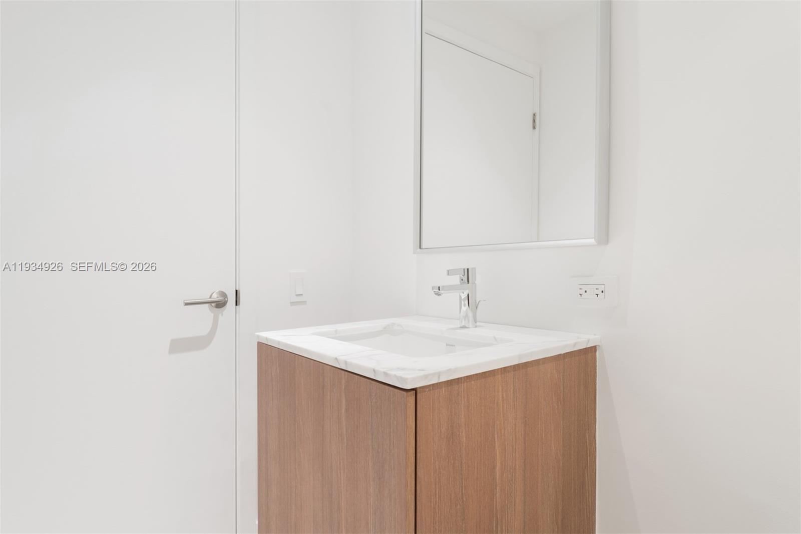 500 Alton Road, Unit 3905 Miami Beach, FL 33139 - Photo 13 of 35 a bathroom with a sink and a mirror