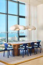 500 Alton Road, Unit 3905 Miami Beach, FL 33139 - Photo 29 of 35 a room with a table chairs and a window