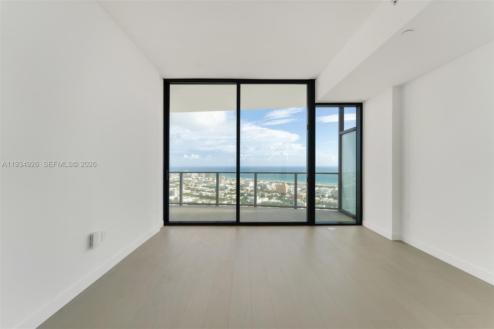 500 Alton Road, Unit 3905 Miami Beach, FL 33139 - Photo 6 of 35 wooden floor in an empty room with a window