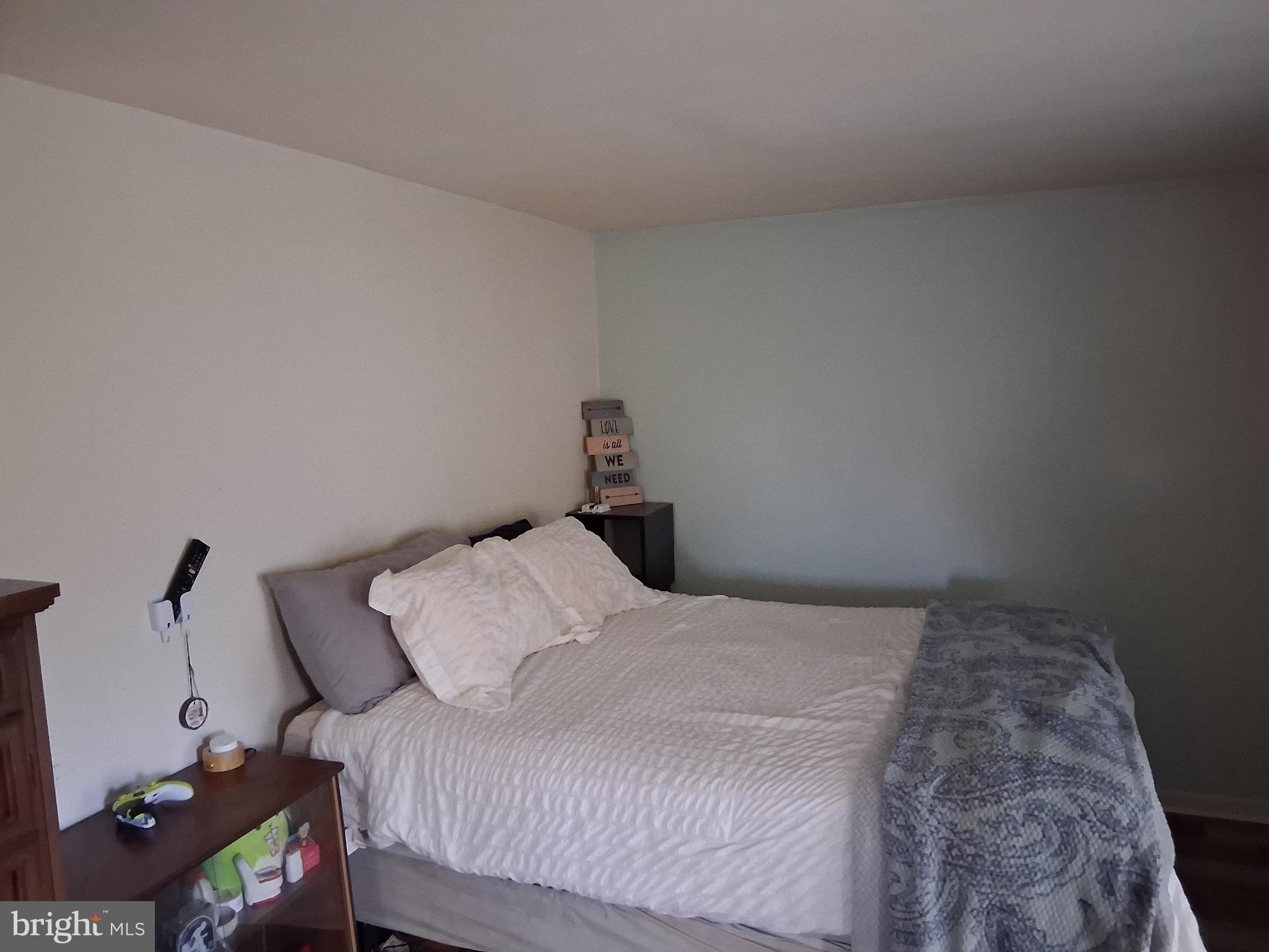 117 Stahl Avenue New Castle, DE 19720 - Photo 18 of 20 a bedroom with a bed and a chandelier