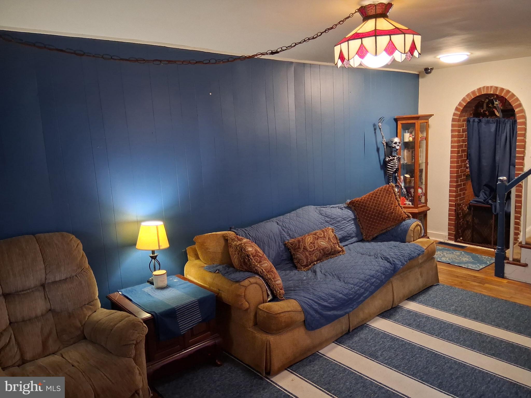 117 Stahl Avenue New Castle, DE 19720 - Photo 2 of 20 a living room with furniture a flat screen tv and a lamp