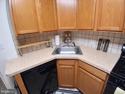 a kitchen with a sink cabinets and appliances