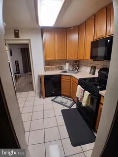 a kitchen with granite countertop a stove a sink dishwasher and a microwave