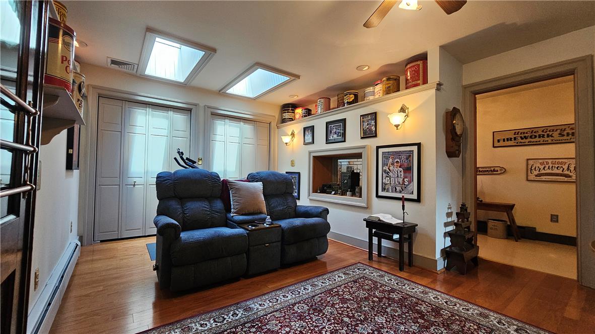 585 Buttermilk Road Hellertown, PA 18055 - Photo 21 of 82 Hardwood flooring and multiple skylights illuminate this welcoming entertainment area.