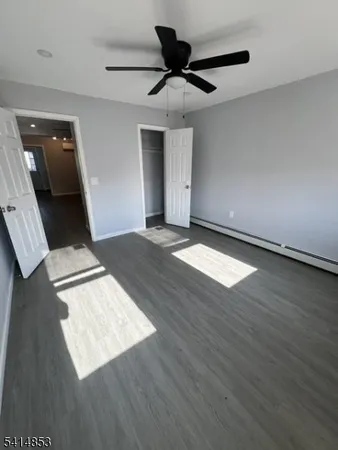 a view of an empty room and wooden floor