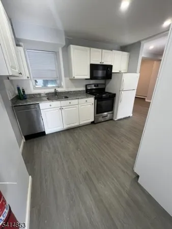 a kitchen with stainless steel appliances a refrigerator sink and microwave