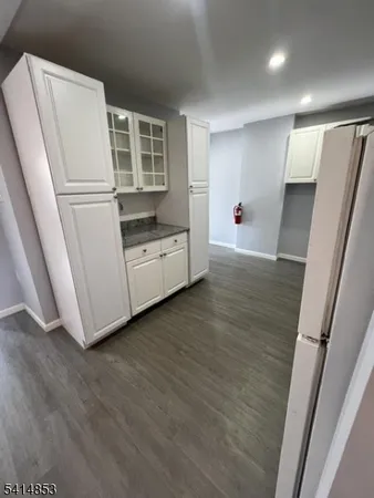 a view of kitchen with wooden floor and electronic appliances