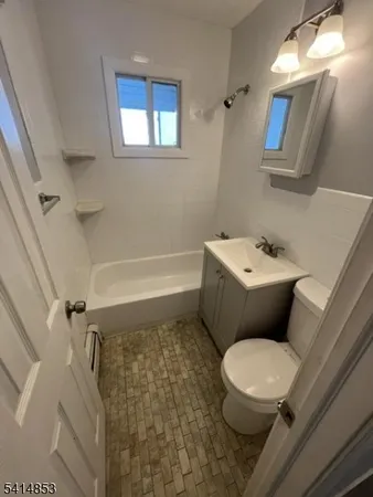 a white toilet sitting next to a bathroom sink and tub