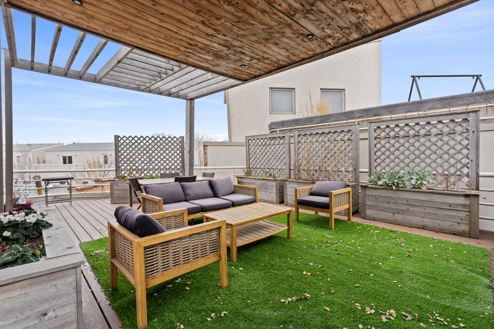 2828 North Talman Avenue, Unit R Chicago, IL 60618 - Photo 27 of 31 a roof deck with couches and wooden fence