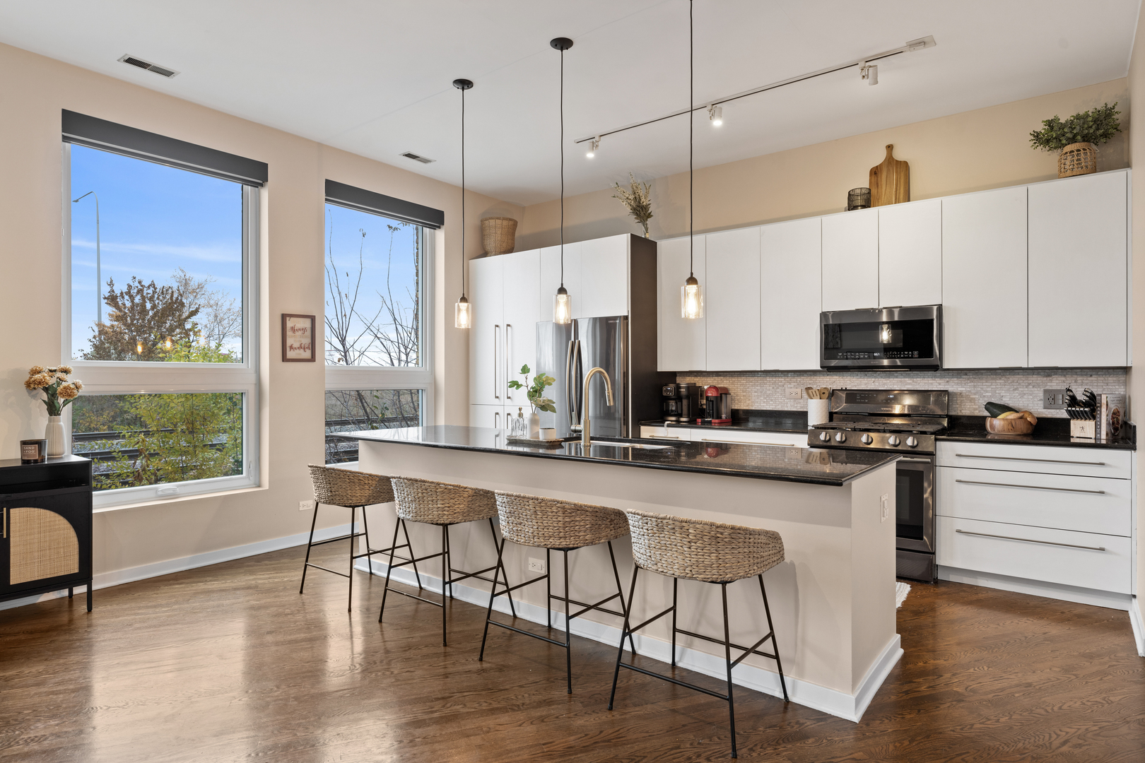 2828 North Talman Avenue, Unit R Chicago, IL 60618 - Photo 7 of 31 a kitchen with stainless steel appliances granite countertop a stove top oven a sink with a dining table and chairs
