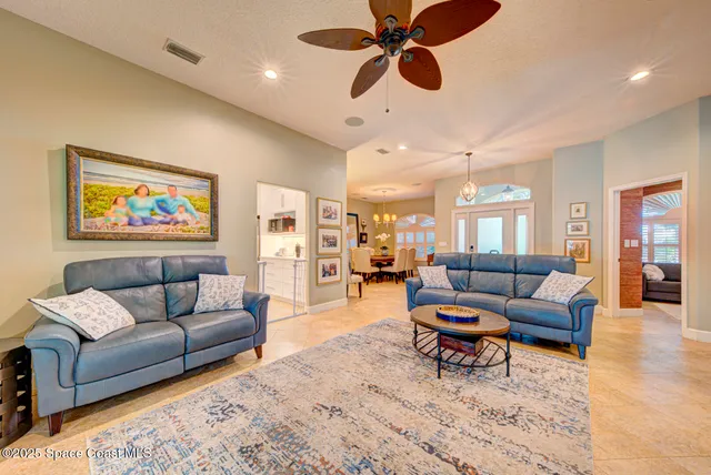 a view of a dining room with furniture and chandelier