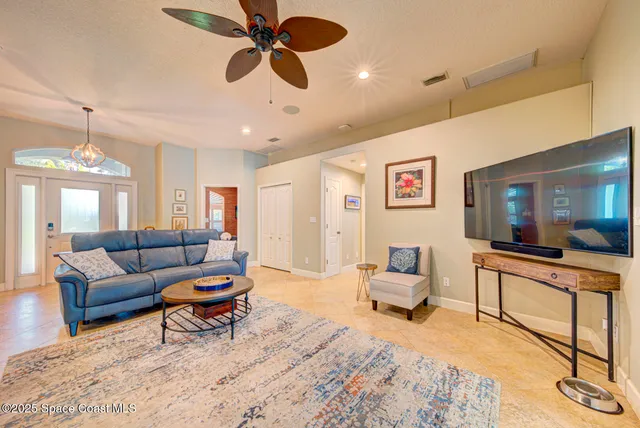 a dining room with furniture and a chandelier