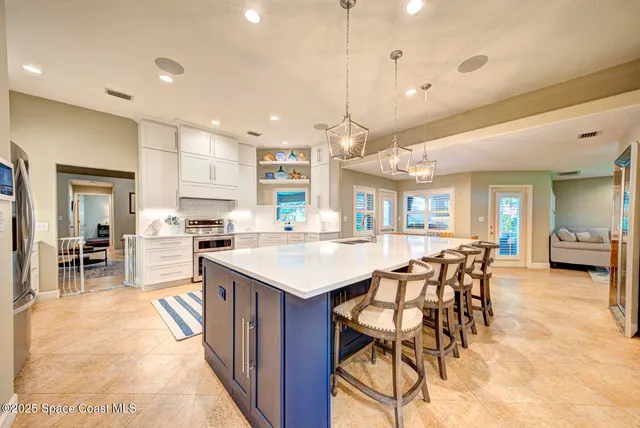 a kitchen with stainless steel appliances a refrigerator stove and cabinets