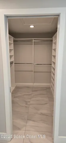 a bedroom with a bed and a walk in closet