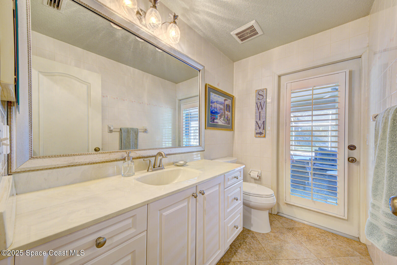 3950 Postridge Trail Melbourne, FL 32934 - Photo 35 of 63 Half Bath Leading to Pool View 2
