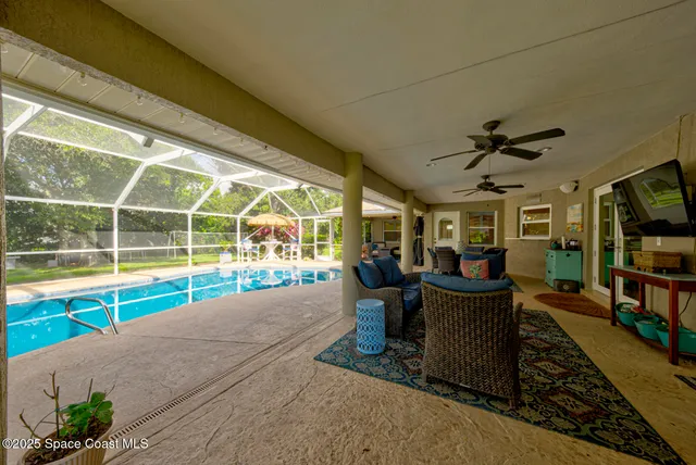 a view of a patio with a table and chairs under an umbrella