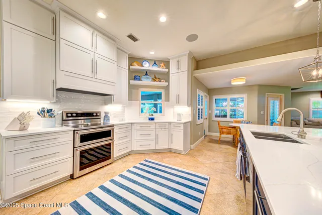 a kitchen with stainless steel appliances granite countertop a sink and cabinets