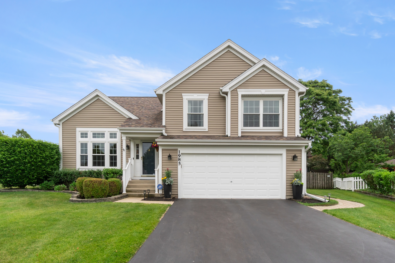 a front view of a house with a yard