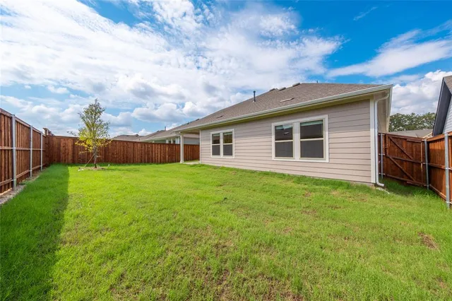 a backyard of a house with lots of green space