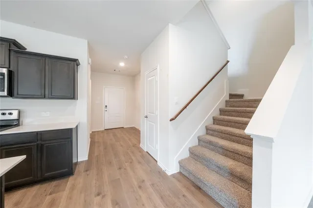 a view of entryway and hall with wooden floor