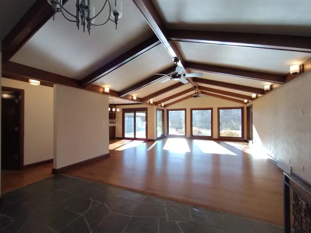 a view of a hall with wooden floor