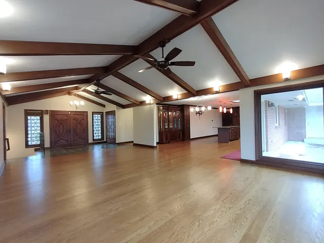 a kitchen with stainless steel appliances granite countertop a stove and a wooden floors
