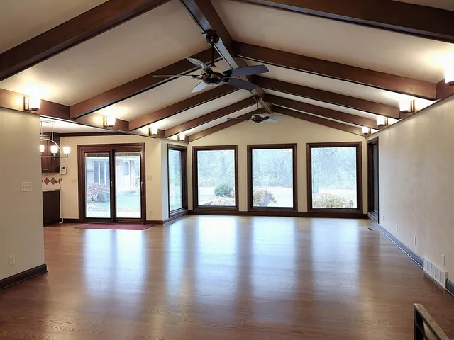a kitchen with stainless steel appliances kitchen island granite countertop a stove and a wooden floors