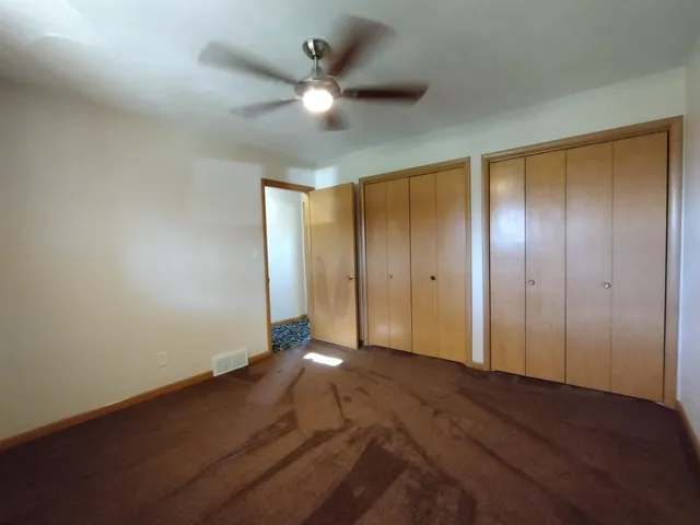 a view of empty room with wooden walls