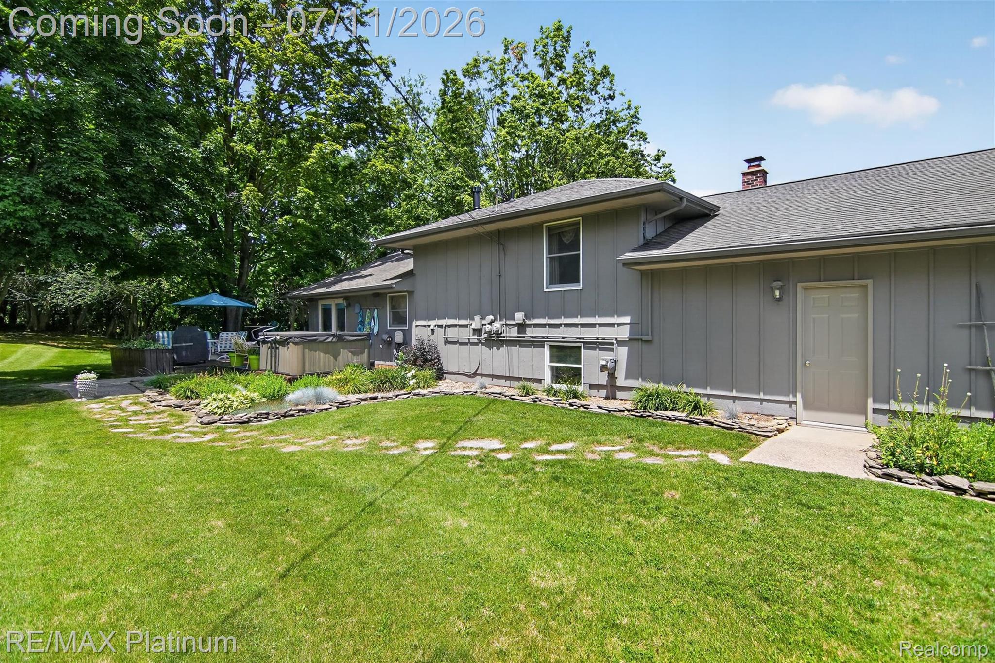 13365 North Territorial Road Gregory, MI 48137 - Photo 48 of 52 Expansive green lawn bordering a gray siding exterior