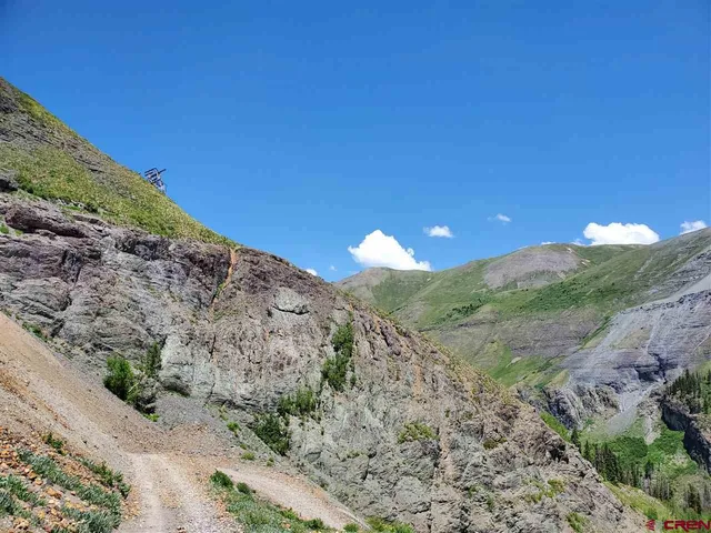 a view of a large building with mountains in the background