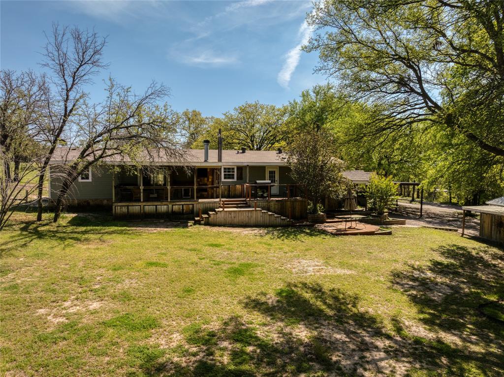 1701 Central Road Weatherford, TX 76088 - Photo 39 of 40 Rear view of property featuring a lawn and a wooden deck