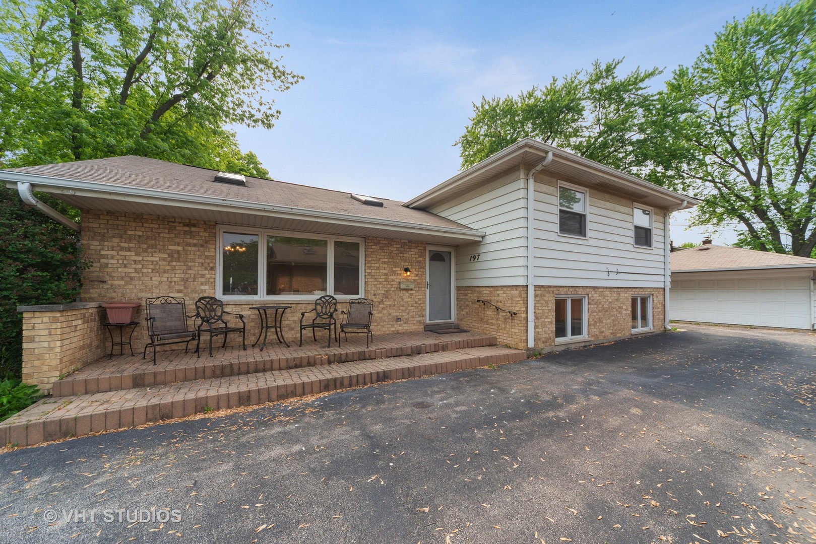 197 West Butterfield Road Elmhurst, IL 60126 - Photo 1 of 15 a front view of a house with a patio